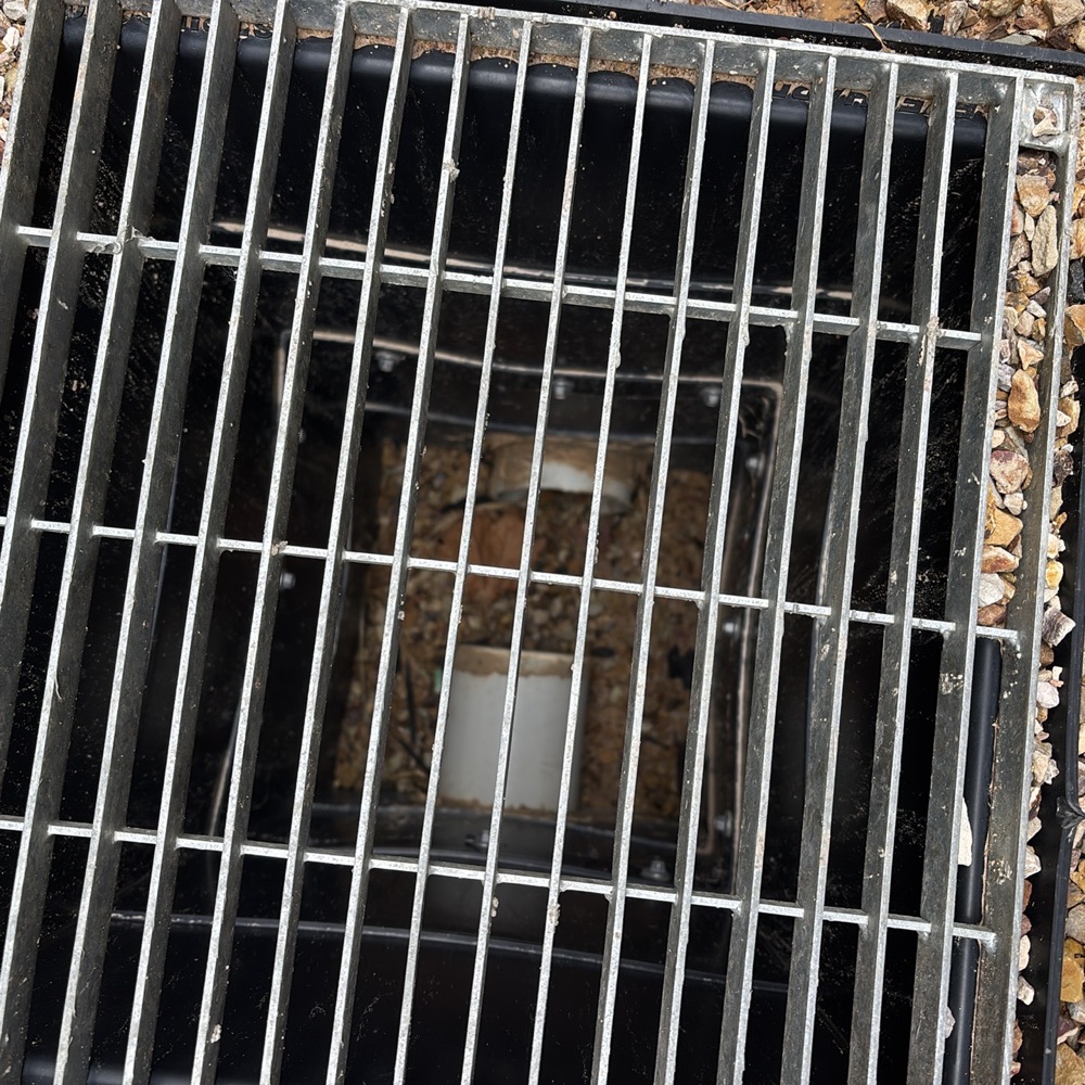 Silt pit filled with debris and soil, risking stormwater backup, recorded during a pre-purchase inspection in Donnybrook